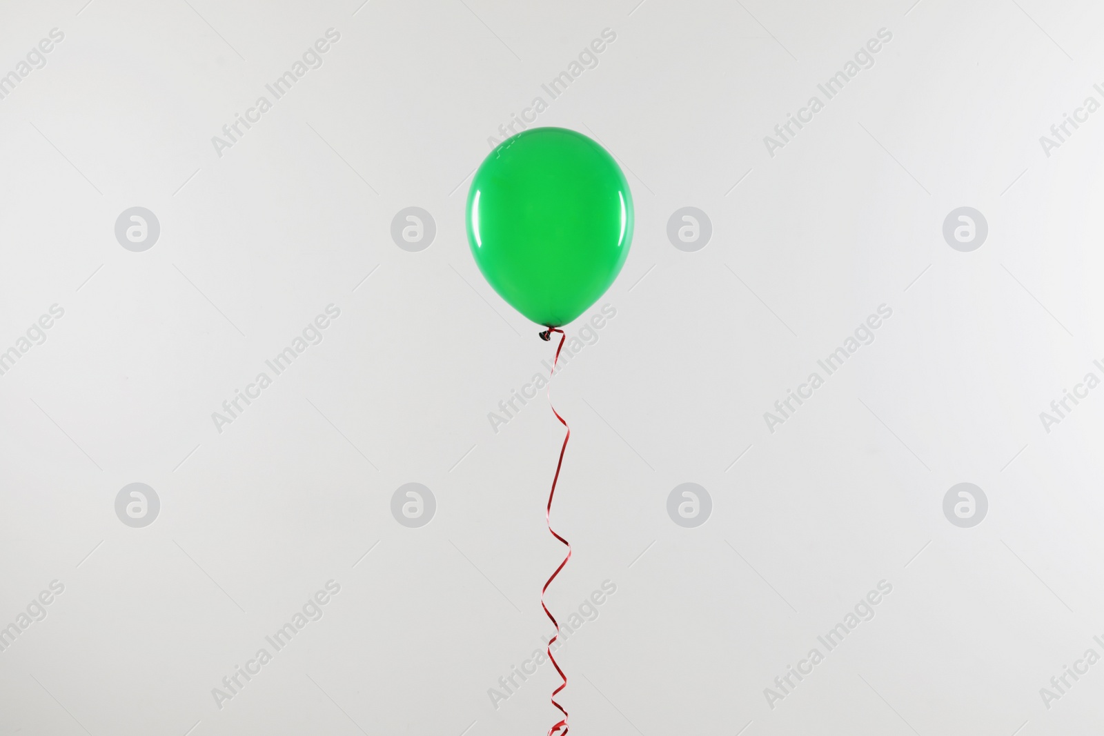 Photo of Bright balloon on light background. Celebration time