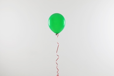 Photo of Bright balloon on light background. Celebration time
