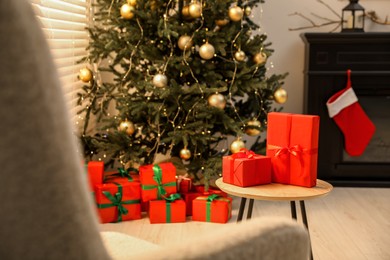 Many beautifully wrapped Christmas gifts in living room