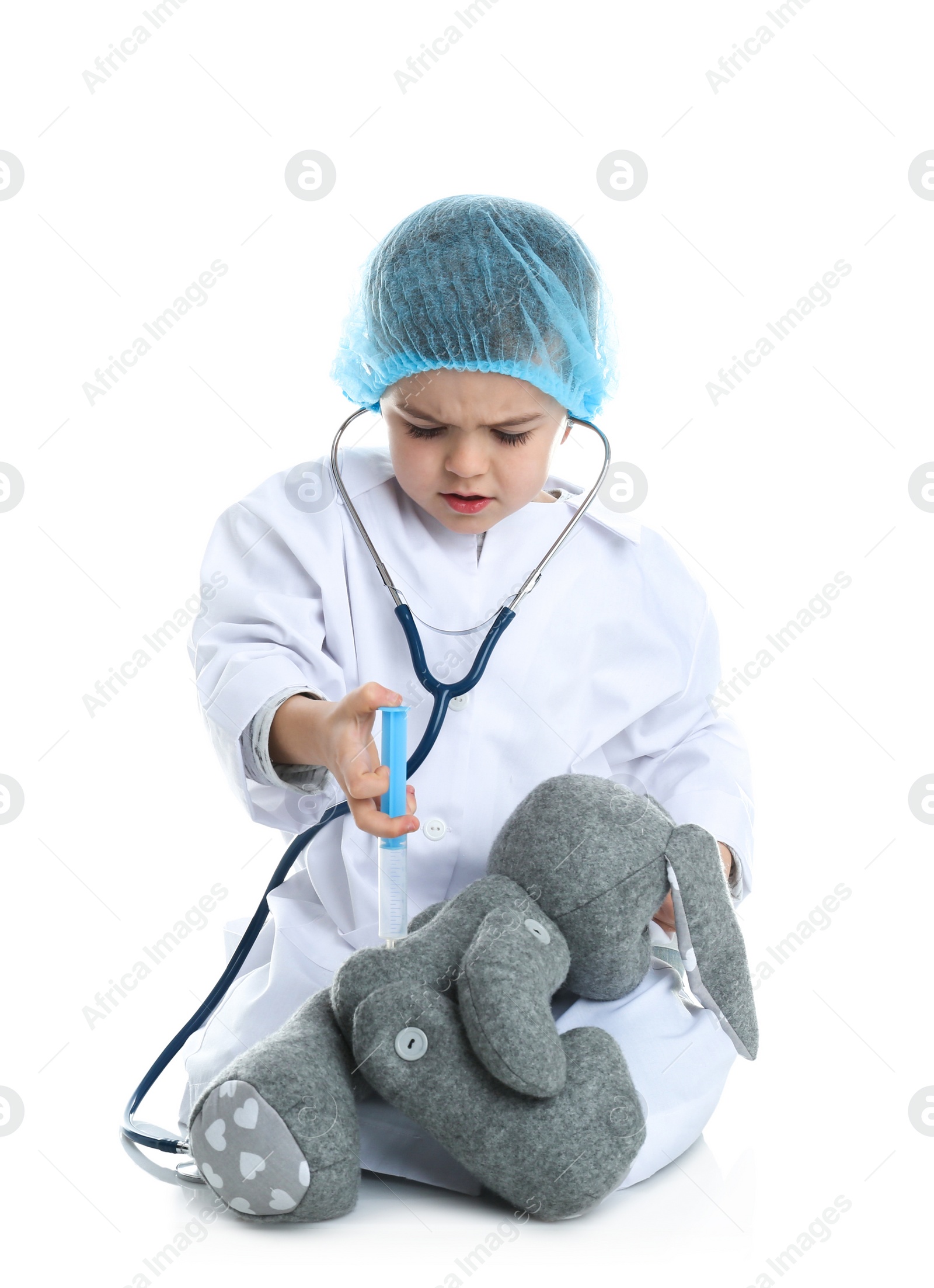 Photo of Cute child playing doctor with stuffed toy on white background