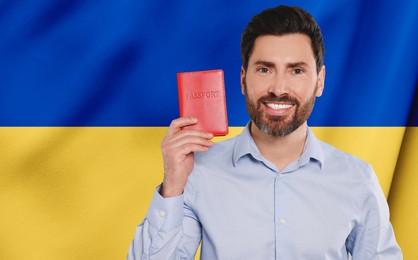 Image of Immigration. Happy man with passport against national flag of Ukraine, space for text. Banner design