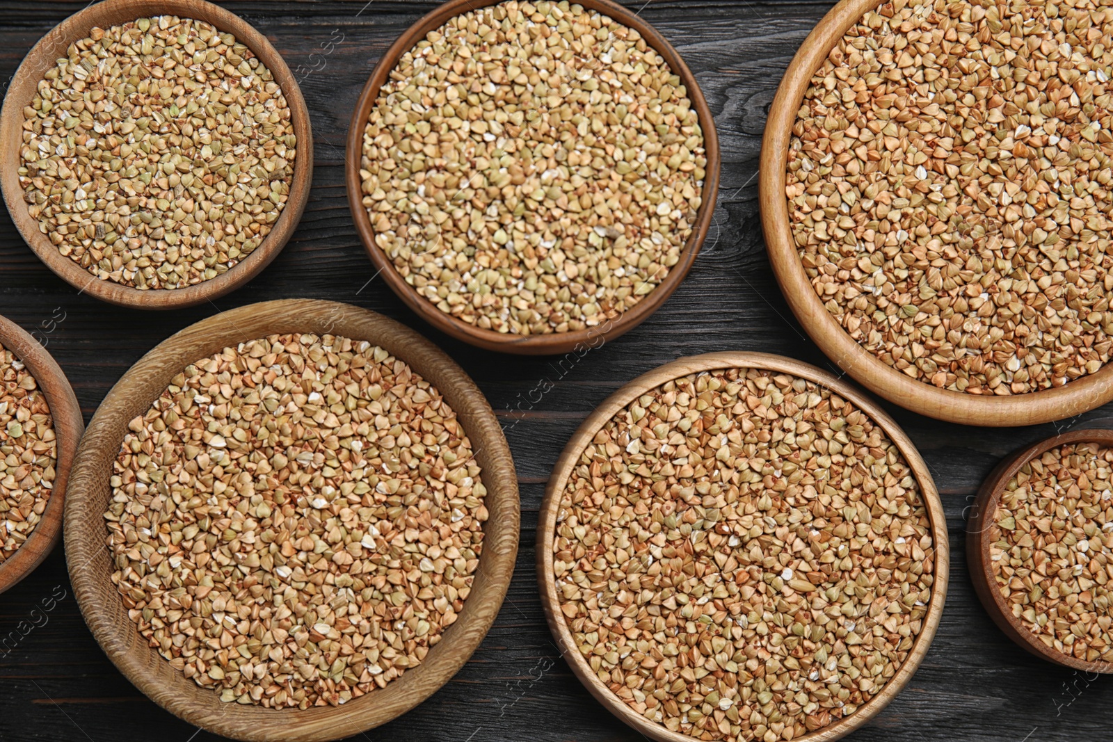 Photo of Flat lay composition with green buckwheat on black wooden table