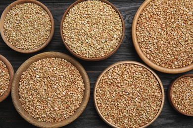 Photo of Flat lay composition with green buckwheat on black wooden table