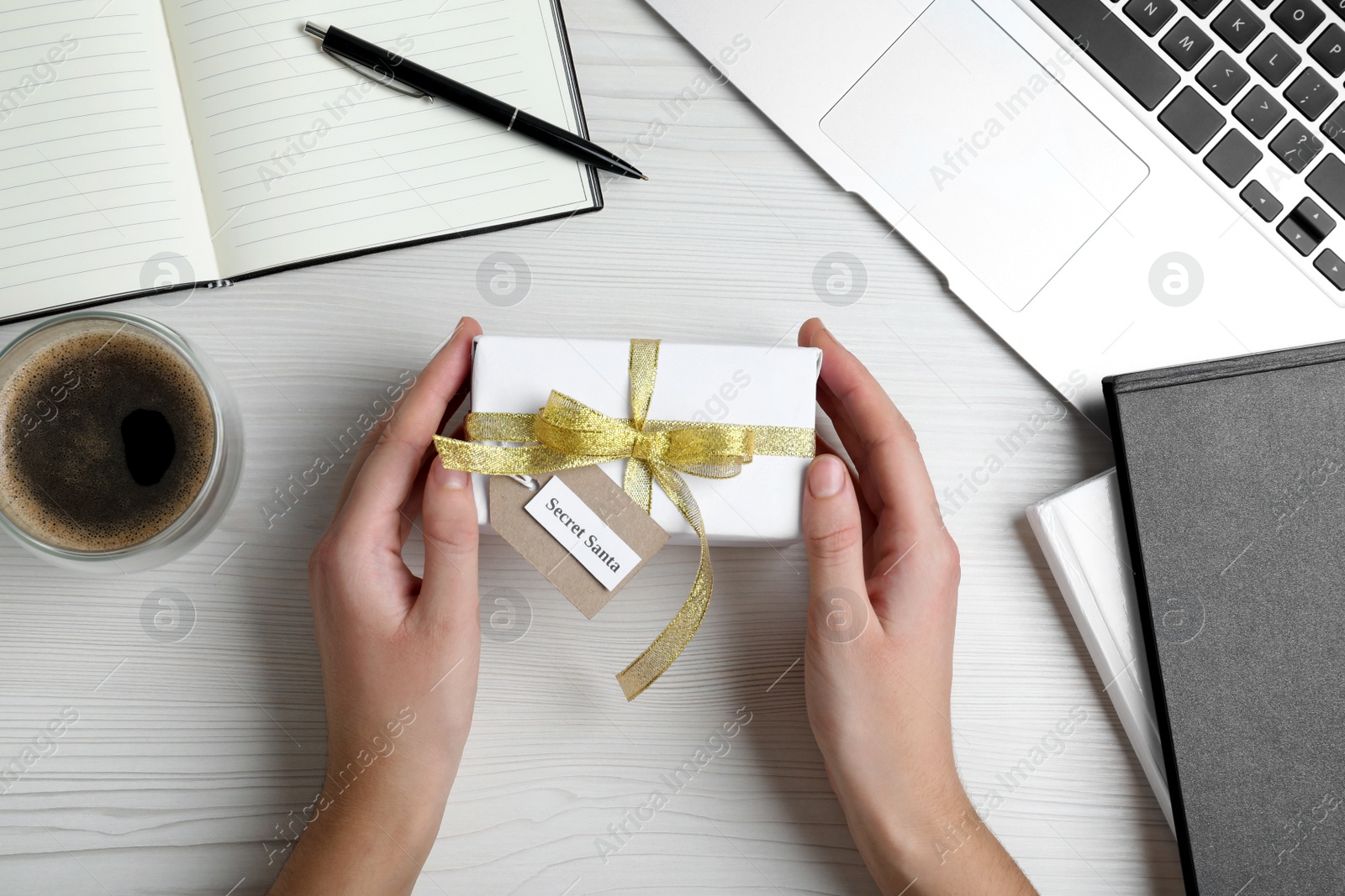 Photo of Woman with present from secret Santa at workplace, top view