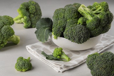 Photo of Fresh raw broccoli on white table, closeup