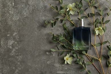 Beautiful composition with bottle of perfume on grey background, flat lay