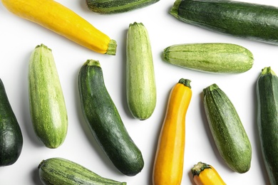 Photo of Fresh ripe zucchinis on white background, top view