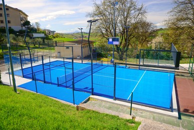 Photo of Empty tennis court outdoors on sunny day