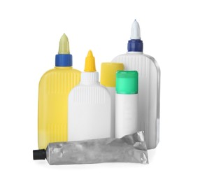 Photo of Different bottles, tube and sticks of glue on white background