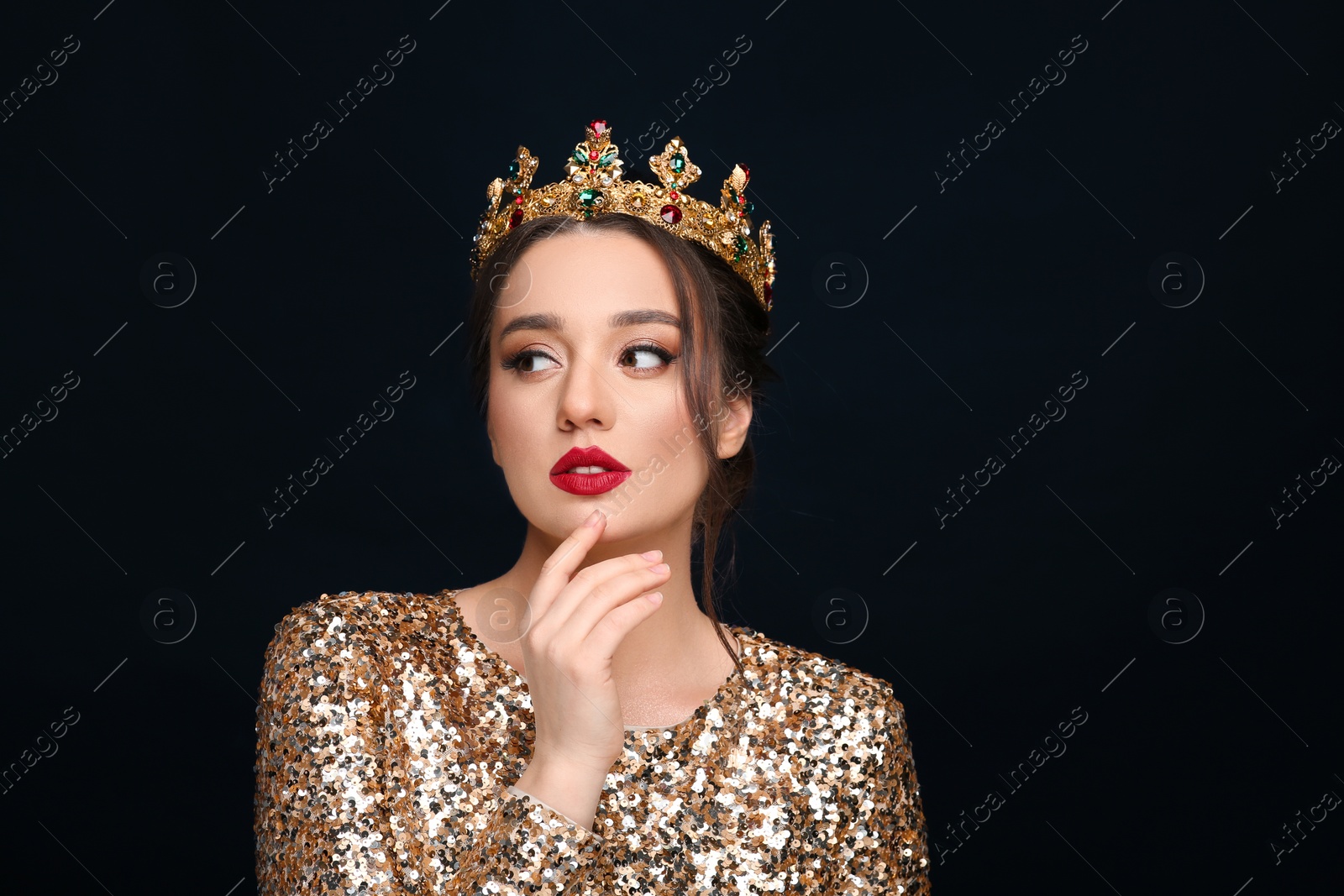 Photo of Beautiful young woman wearing luxurious crown on black background, space for text