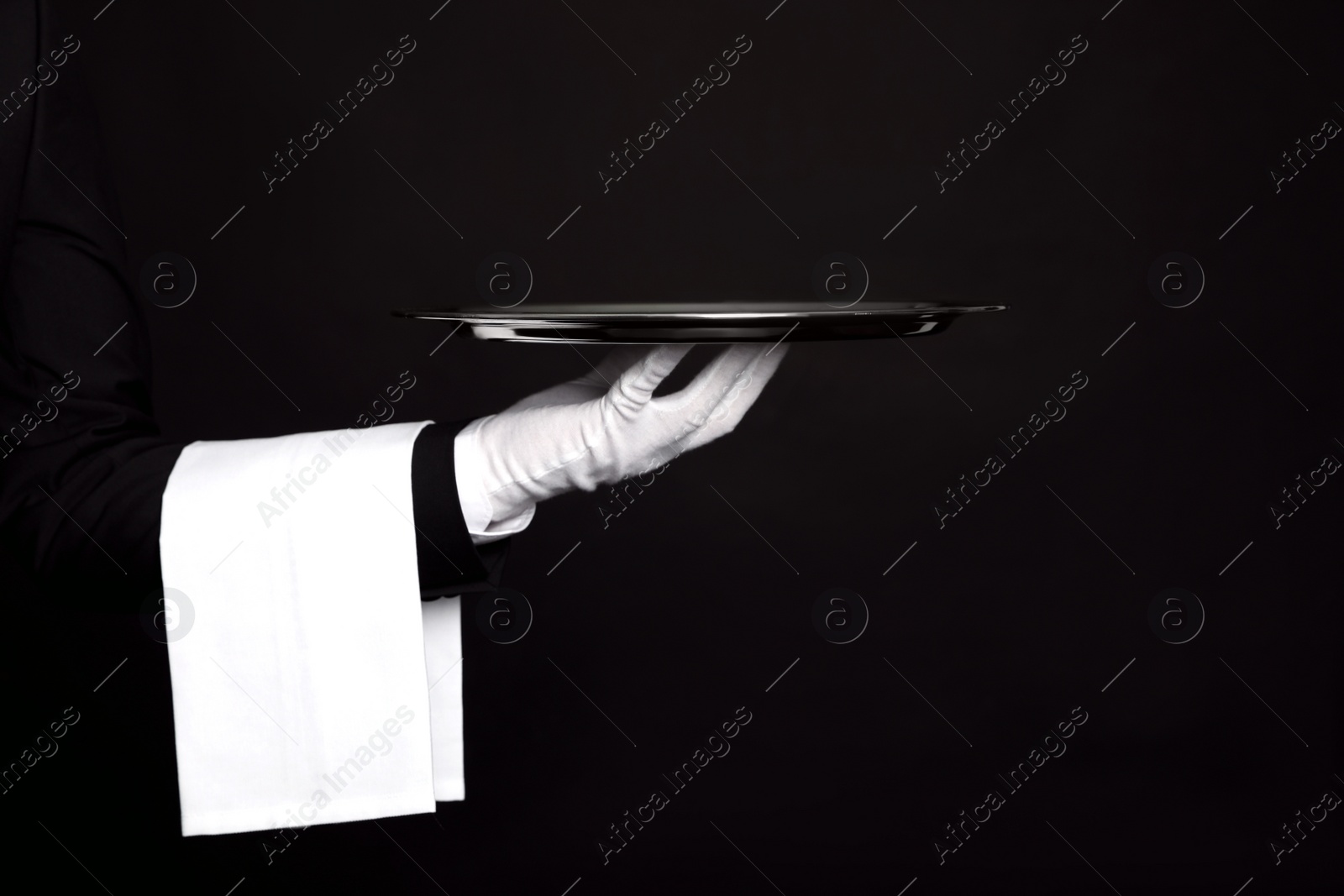 Photo of Butler with tray on black background, closeup