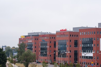 Photo of Warsaw, Poland - September 10, 2022: Buildings with many modern logos outdoors