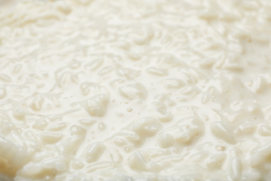 Photo of Delicious rice pudding as background, closeup view