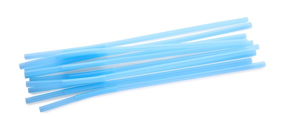 Light blue plastic cocktail straws on white background, top view