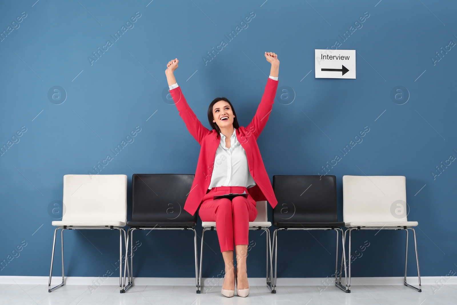 Photo of Young woman being happy after success job interview, indoors