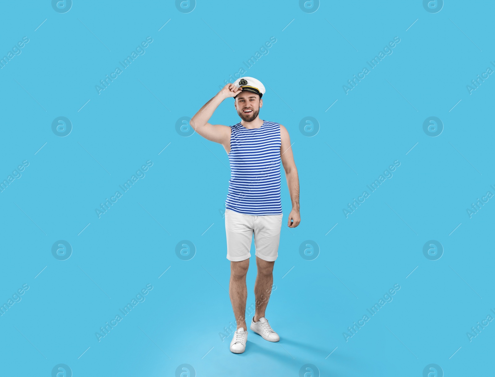 Photo of Full length portrait of sailor on light blue background