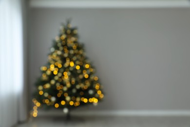 Photo of Blurred view of beautifully decorated Christmas tree indoors, space for text