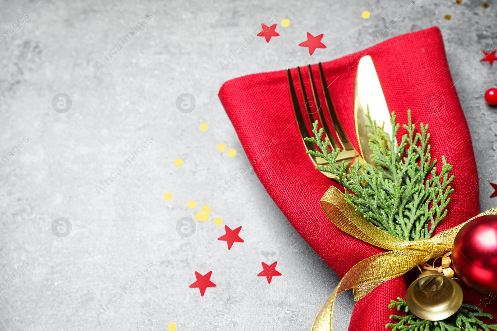 Photo of Cutlery set on grey table, closeup with space for text. Christmas celebration