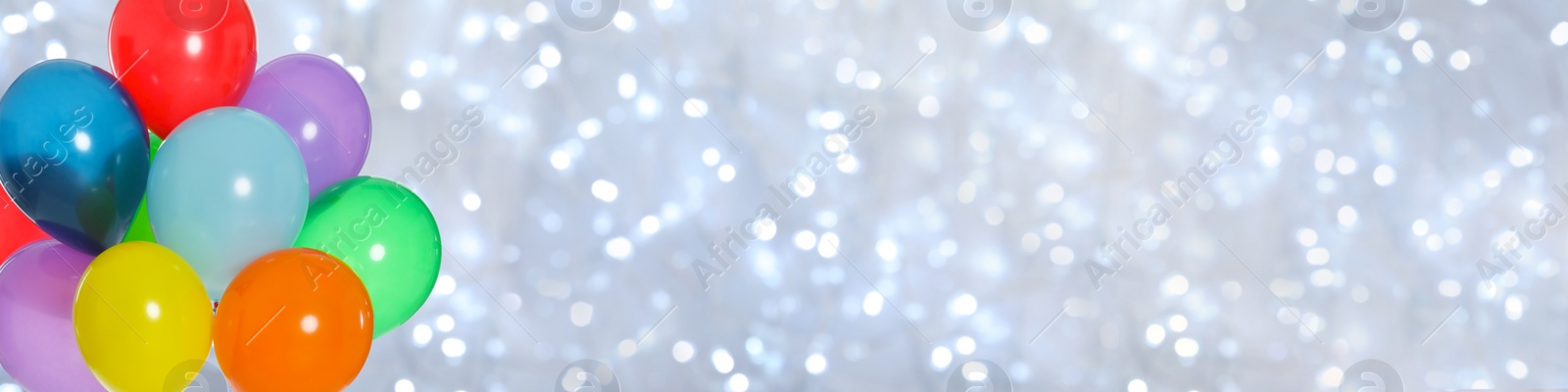 Image of Bright balloons on blurred background with bokeh effect, space for text. Banner design