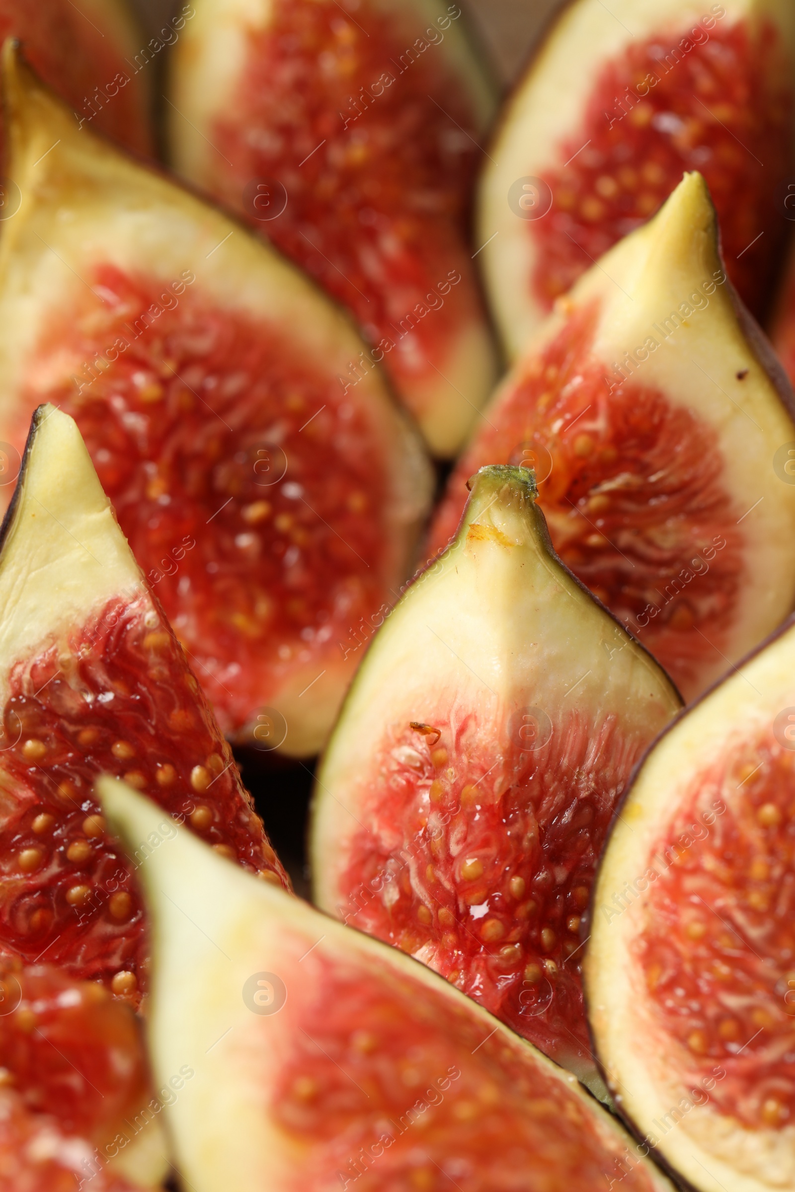 Photo of Slices of tasty fresh figs as background, closeup