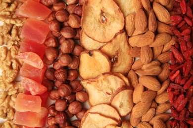 Photo of Mix of delicious dried nuts and fruits as background, top view