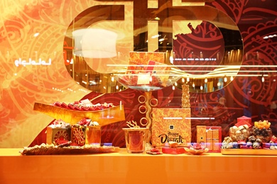 Photo of DUBAI, UNITED ARAB EMIRATES - NOVEMBER 04, 2018: Showcase of store with luxury sweets in shopping mall