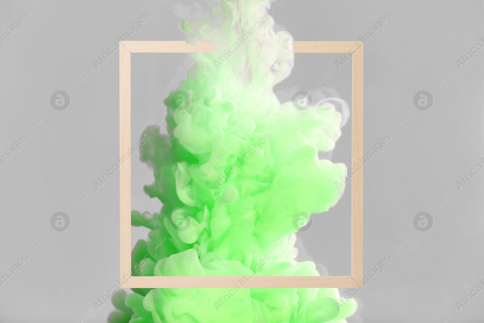 Image of Splash of light green ink and frame on grey background