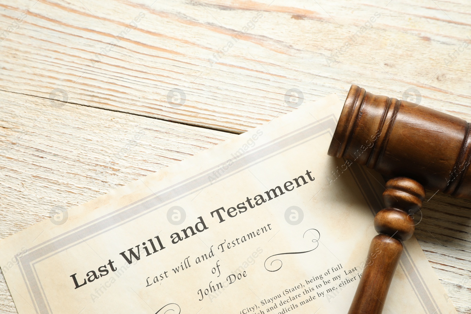 Photo of Last Will and Testament with gavel on white wooden table, top view. Space for text