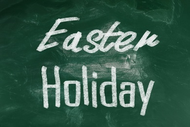 Image of Text Easter Holiday on green chalkboard. School break 