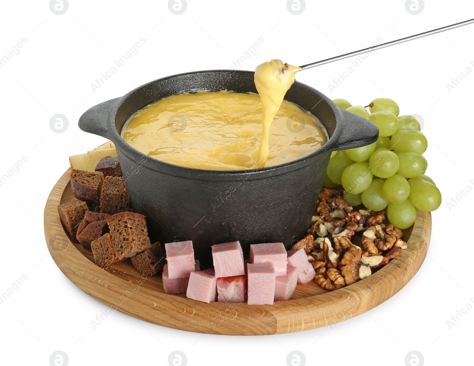 Photo of Dipping piece of bread into fondue pot with tasty melted cheese isolated on white