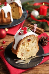 Photo of Composition with piece of traditional homemade Christmas cake on wooden table, closeup