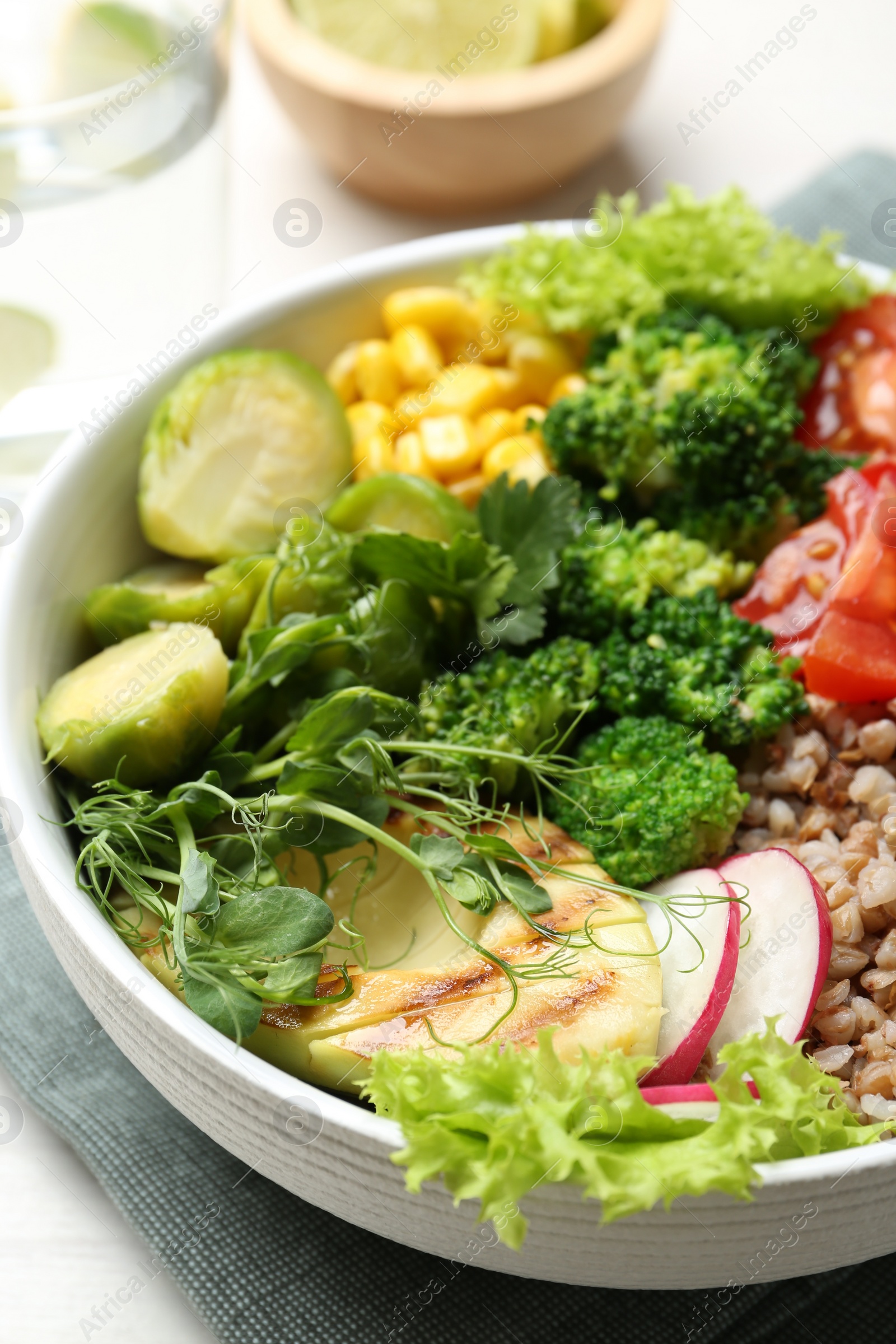 Photo of Healthy meal. Tasty products in bowl on white table, closeup