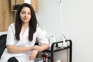 Photo of Cosmetologist in medical uniform in modern clinic