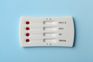 Photo of Disposable multi-infection express test on light blue background, top view