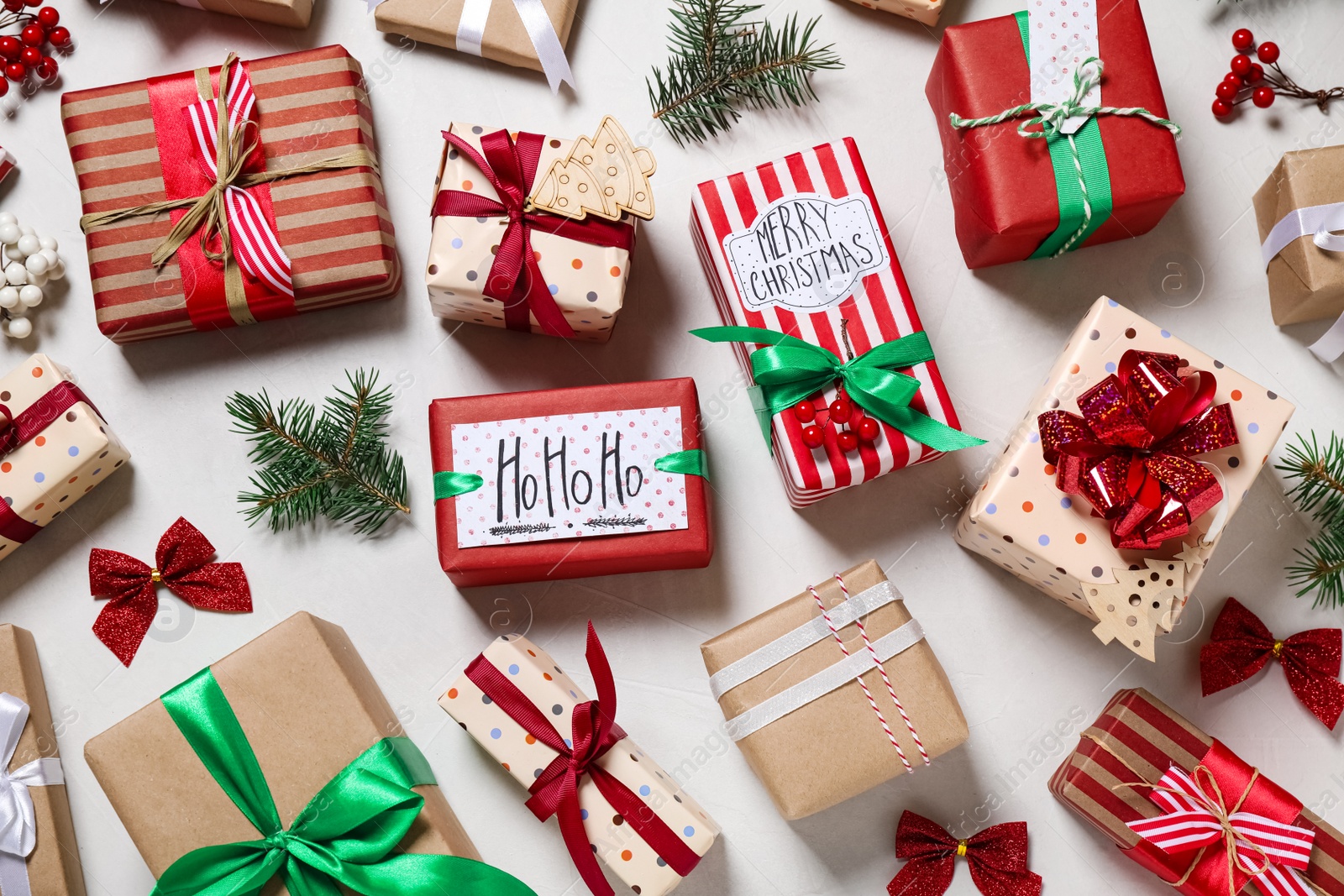 Photo of Flat lay composition of color Christmas gift boxes on light background