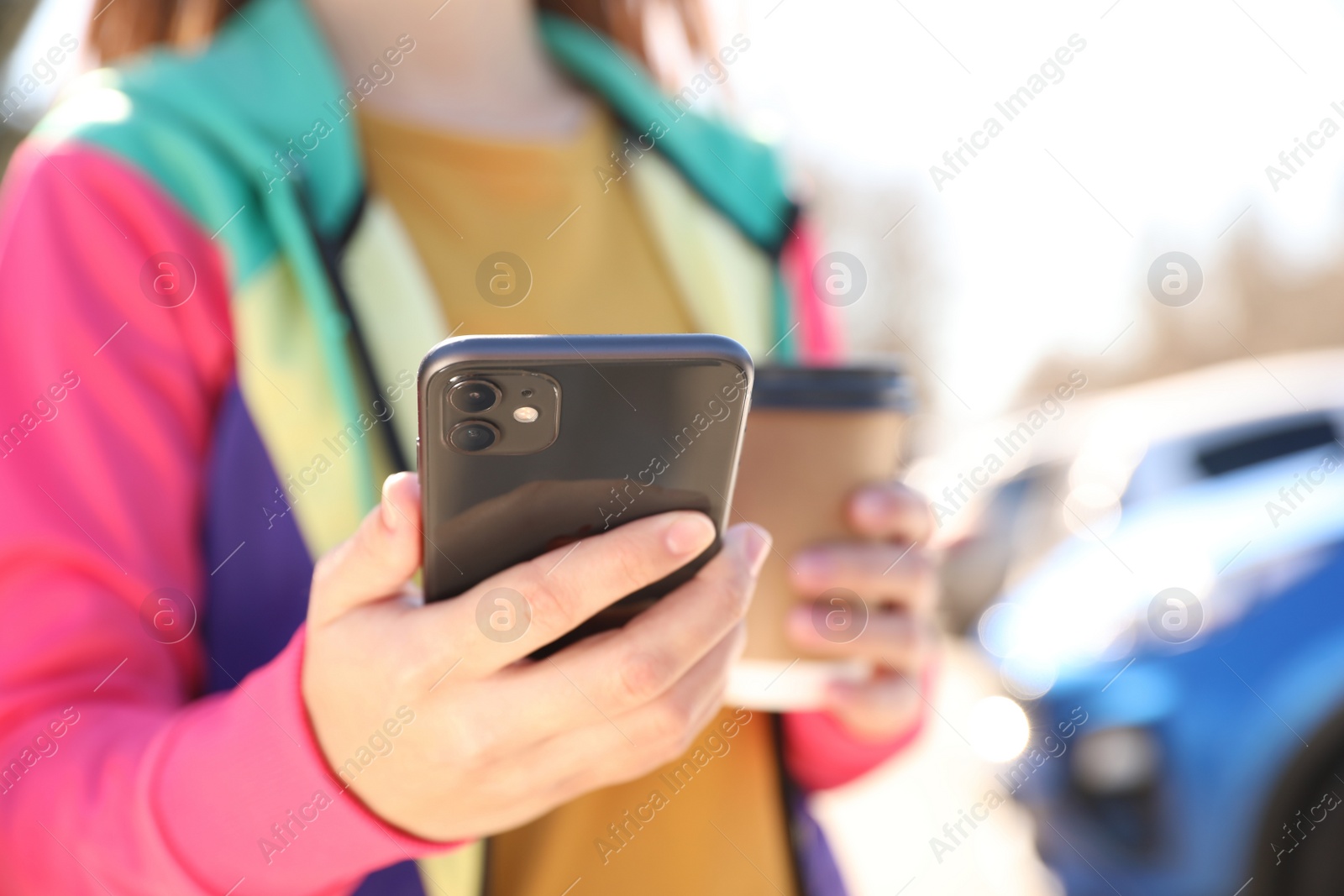 Photo of MYKOLAIV, UKRAINE - MARCH 16, 2020: Woman holding iPhone 11 Black outdoors, closeup