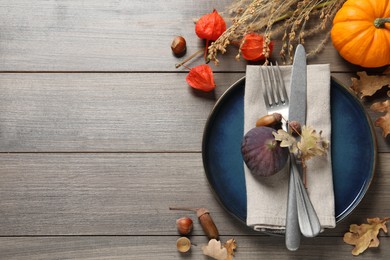 Autumn table setting on wooden background, flat lay. Space for text