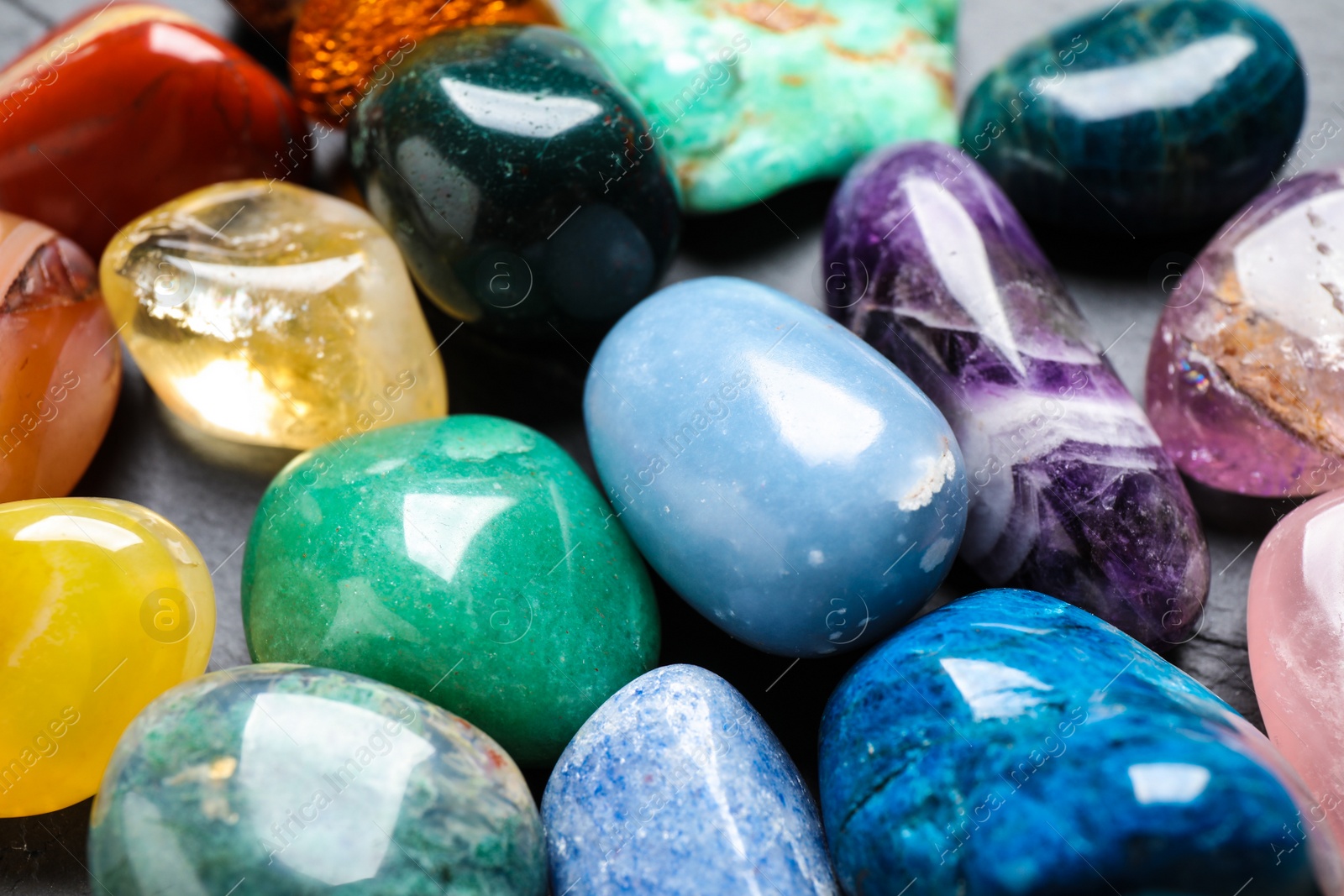 Photo of Different precious gemstones as background, closeup view