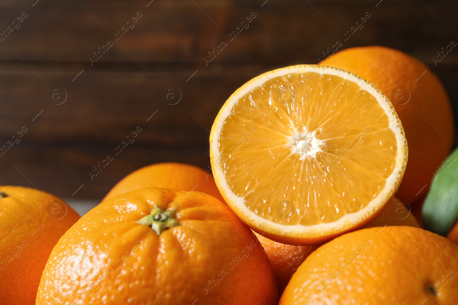 Photo of Fresh oranges on blurred background, closeup. Healthy fruits