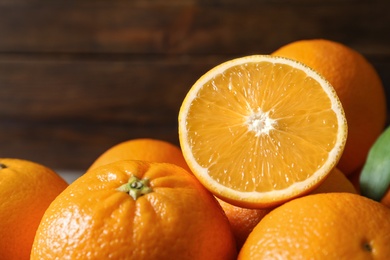 Photo of Fresh oranges on blurred background, closeup. Healthy fruits