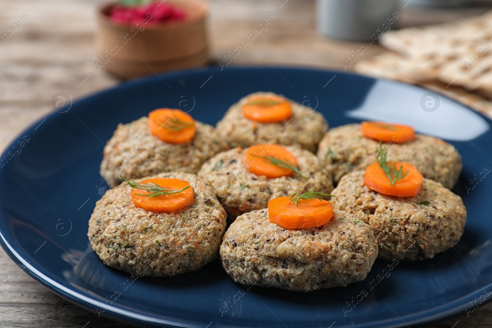 Photo of Plate of traditional Passover (Pesach) gefilte fish on wooden table, closeup