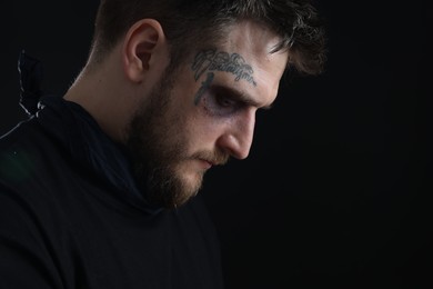 Photo of Man with bruise on dark background, space for text. Hostage