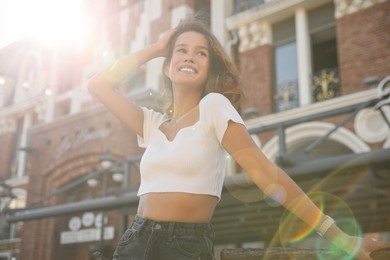 Photo of Portrait of happy young woman on city street