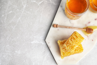 Photo of Flat lay composition with delicious honey on marble table. Space for text