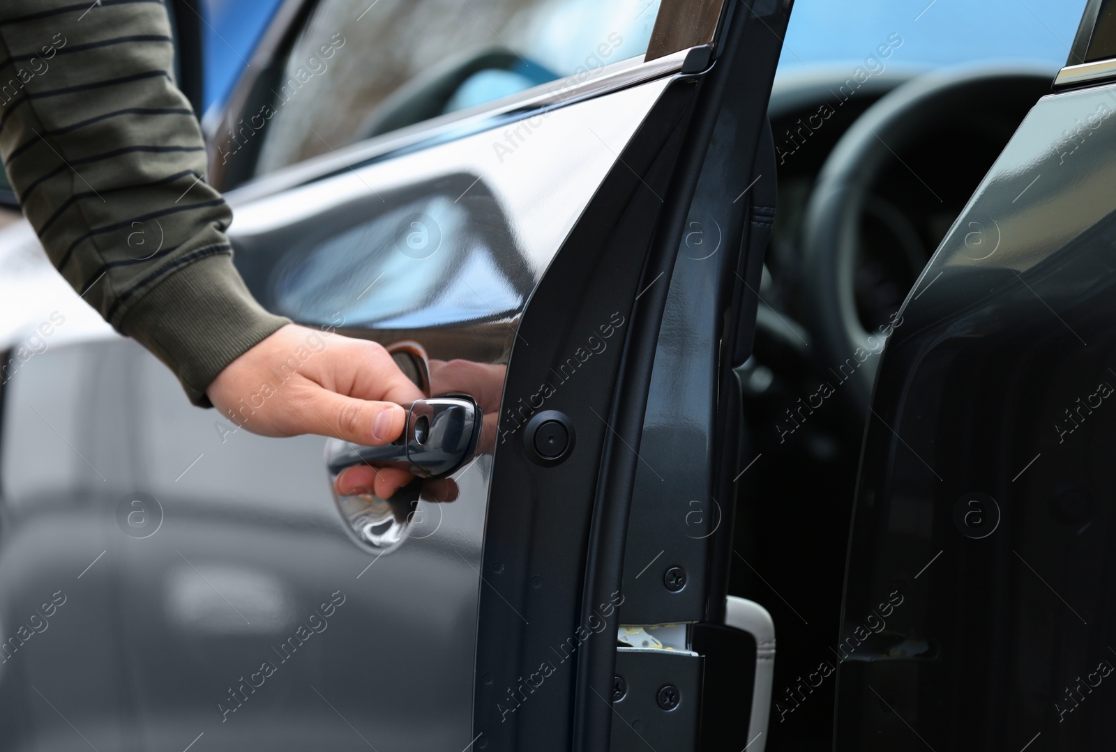 Photo of Closeup view of man opening car door