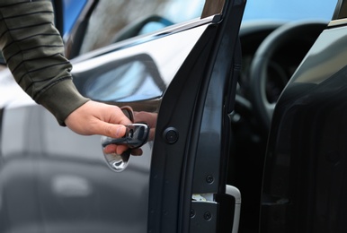 Closeup view of man opening car door