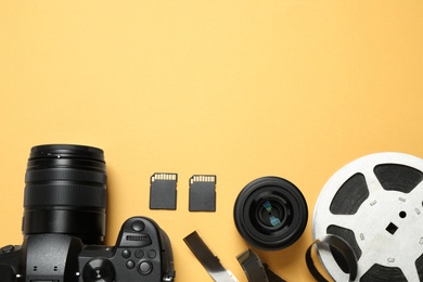 Flat lay composition with camera and video production equipment on yellow background. Space for text