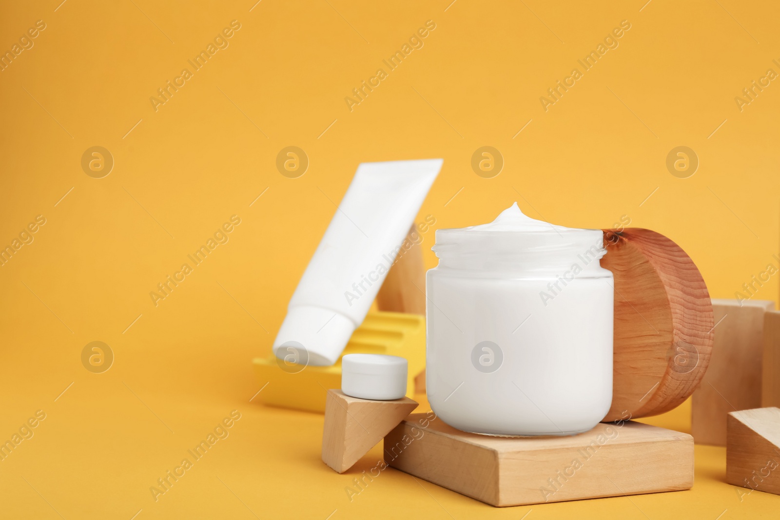 Photo of Composition with different cosmetic products on orange background, space for text