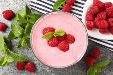 Delicious raspberry mousse with mint on grey table, flat lay