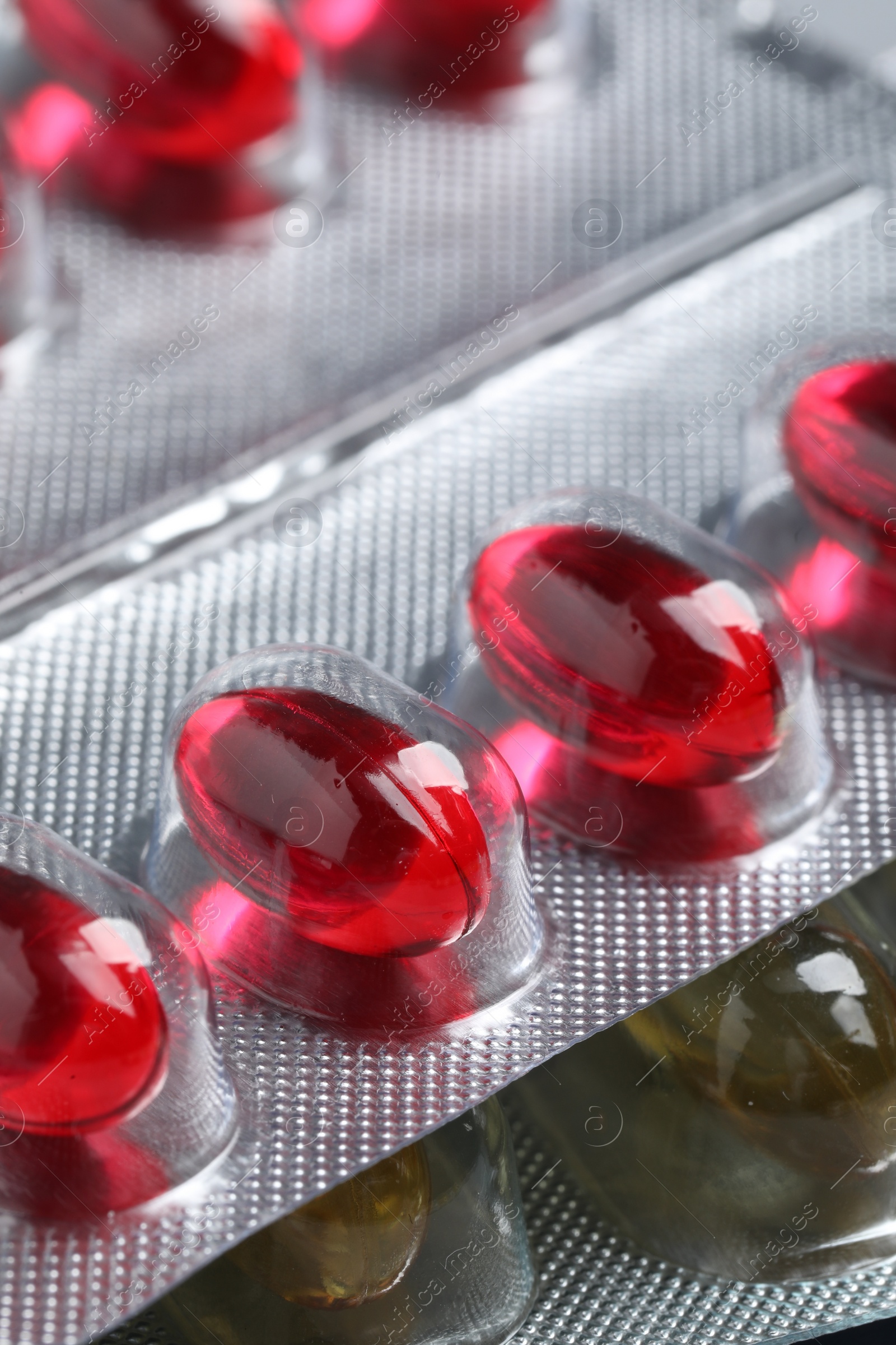 Photo of Different pills in blisters as background, closeup